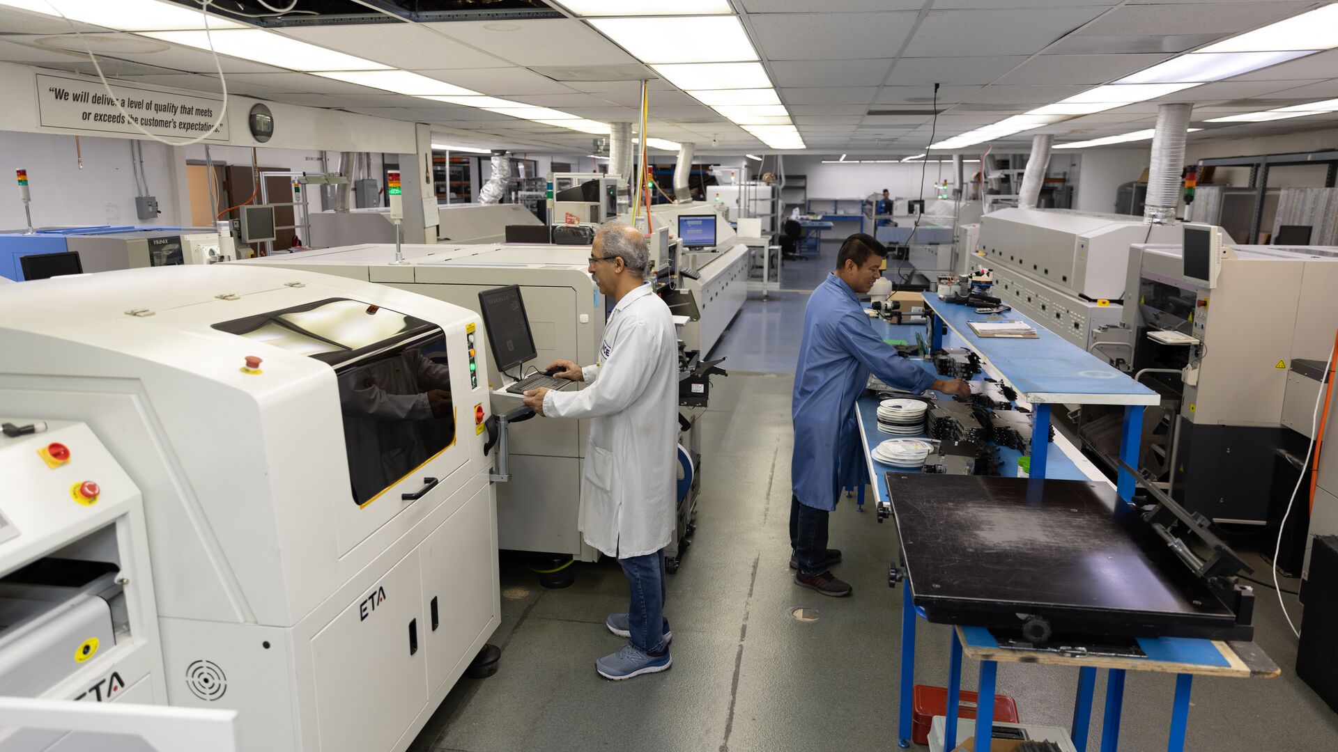 Operators running one of the SMT production lines at World Class Electronics in Newbury Park, California